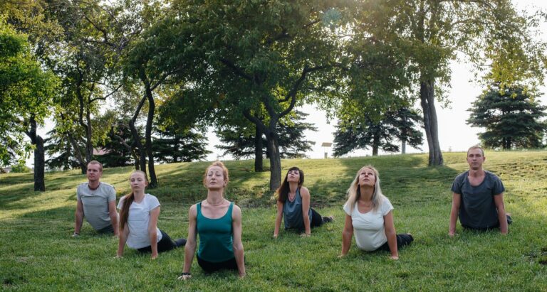 Outdoor group yoga session for office staff in a park